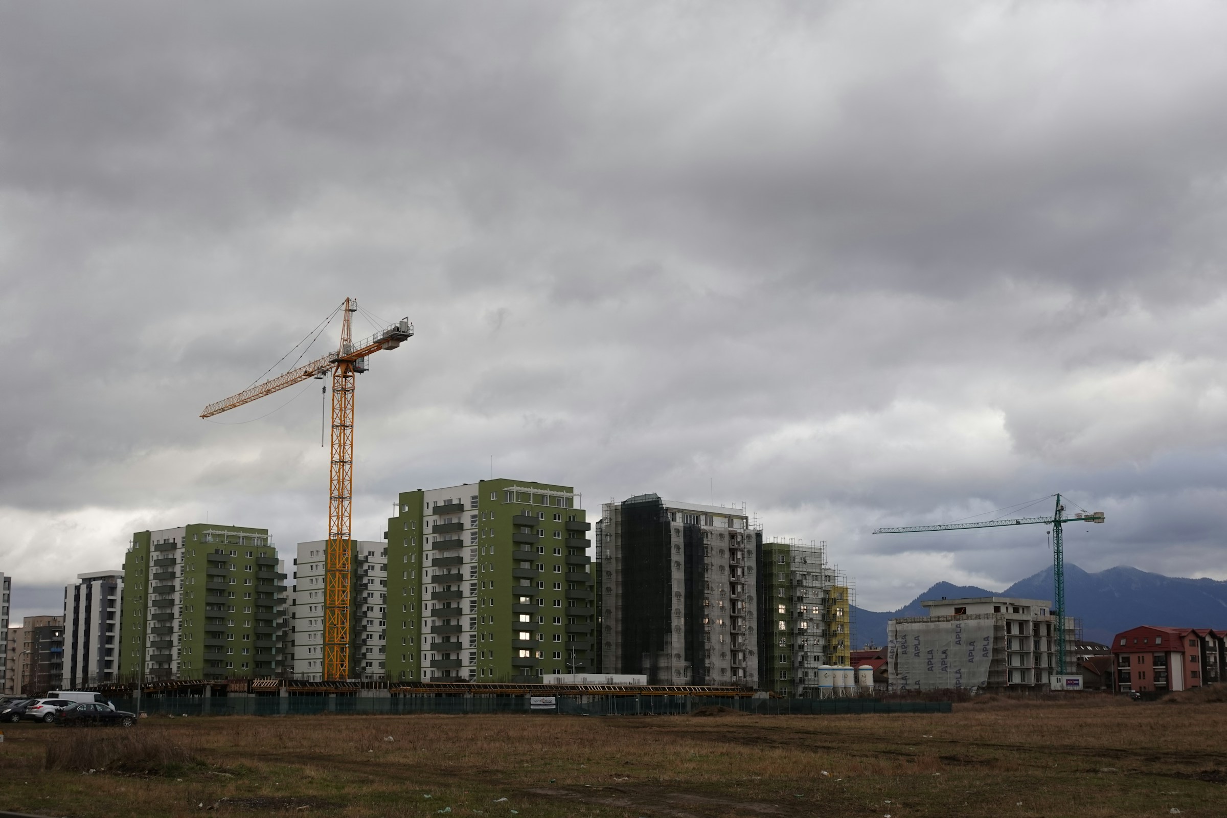A residential development under construction with a tower crane